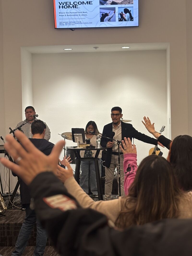 Hands raised in worship during a Sunday service